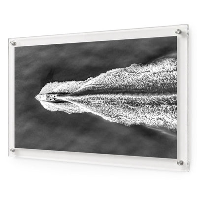 The Getaway black and white acrylic wall art featuring a speedboat on open water