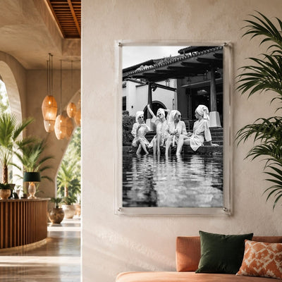 Vertical black and white wall art with women enjoying a resort pool