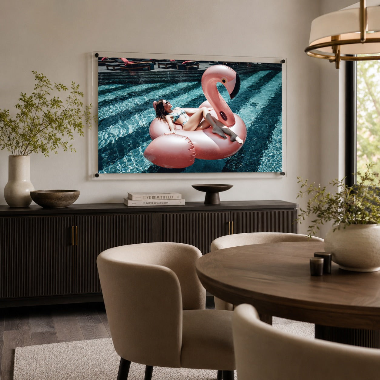 Pink flamingo pool wall art in a modern dining room with upholstered chairs