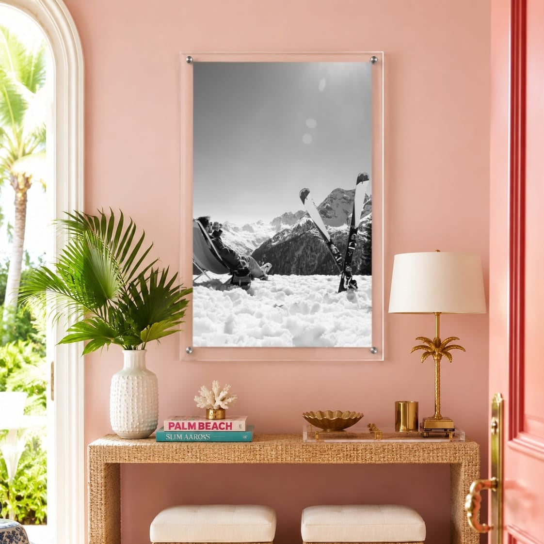 Black and white ski wall art displayed in a colorful pink entryway space