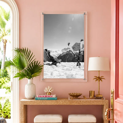 Black and white ski wall art displayed in a colorful pink entryway space