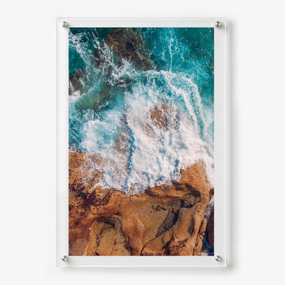 Ocean and rock acrylic wall art in vibrant blue and earth tones