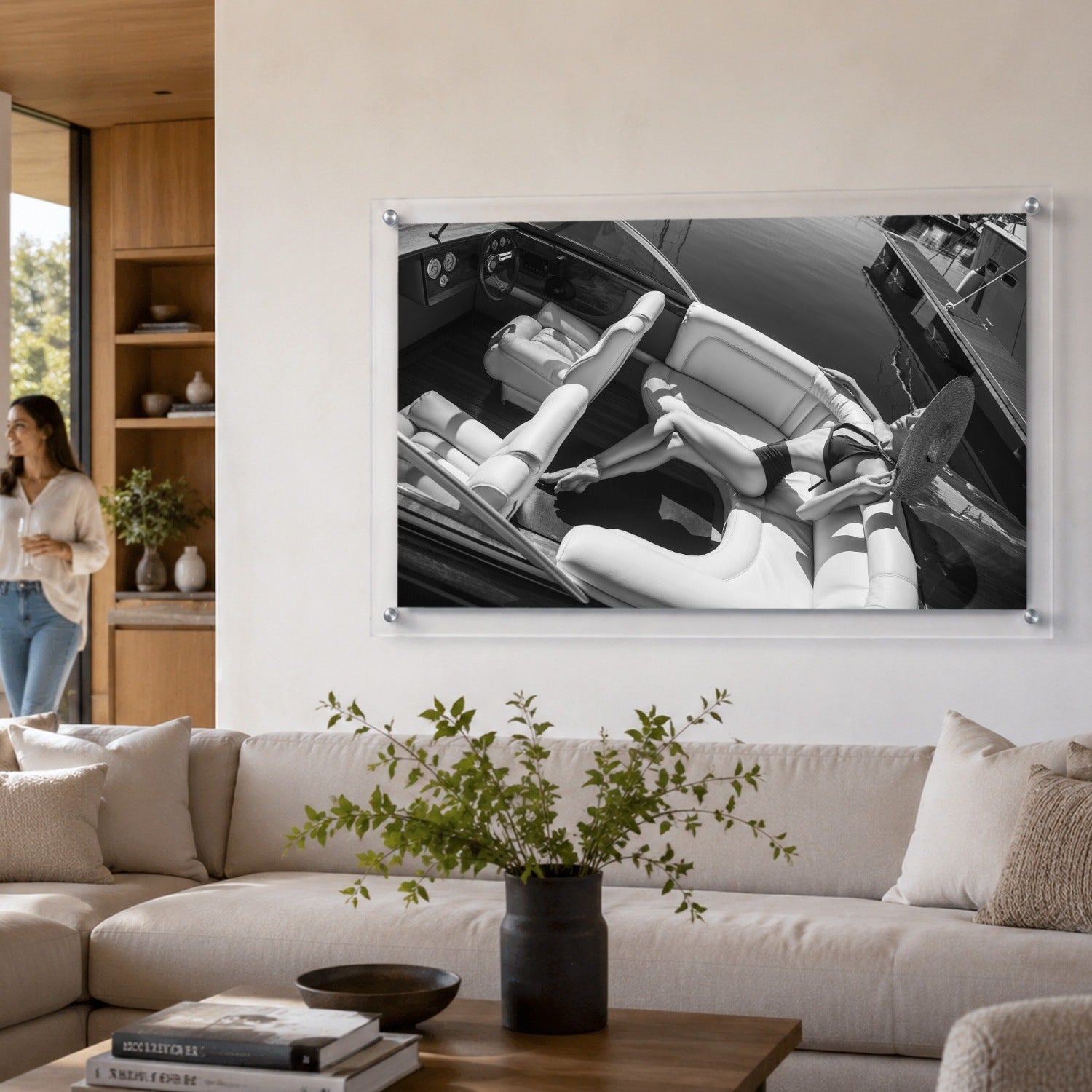 Sea La Vie BW lifestyle wall art above a sofa with a woman walking by