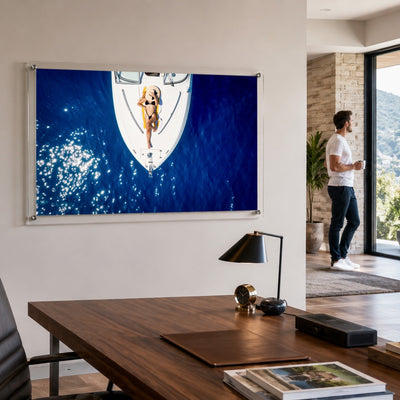 Sun Deck Society wall art in an office space with a man by the window