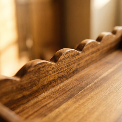 Detailed view of the scalloped wooden serving tray
