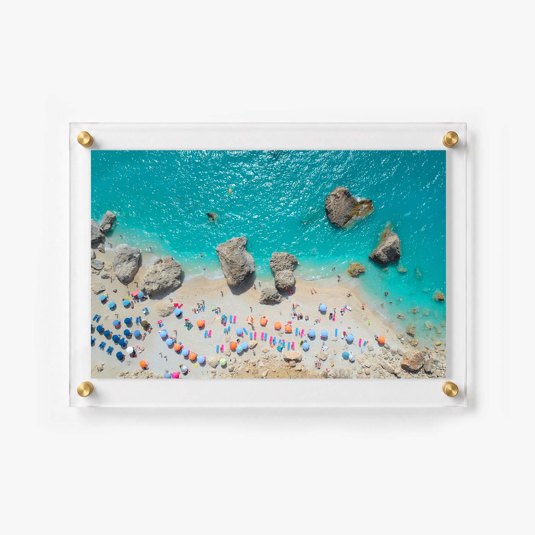 Aerial coastal artwork showing swimmers, sunbathers, beach chairs, and rocks