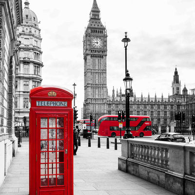 Red London telephone box and double decker buses with view of Big Ben