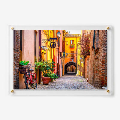 Acrylic wall art featuring a colorful cobblestone alley with bicycles and historic brick buildings