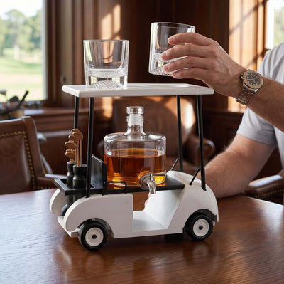 Man lifting a whiskey glass from a white golf cart decanter set