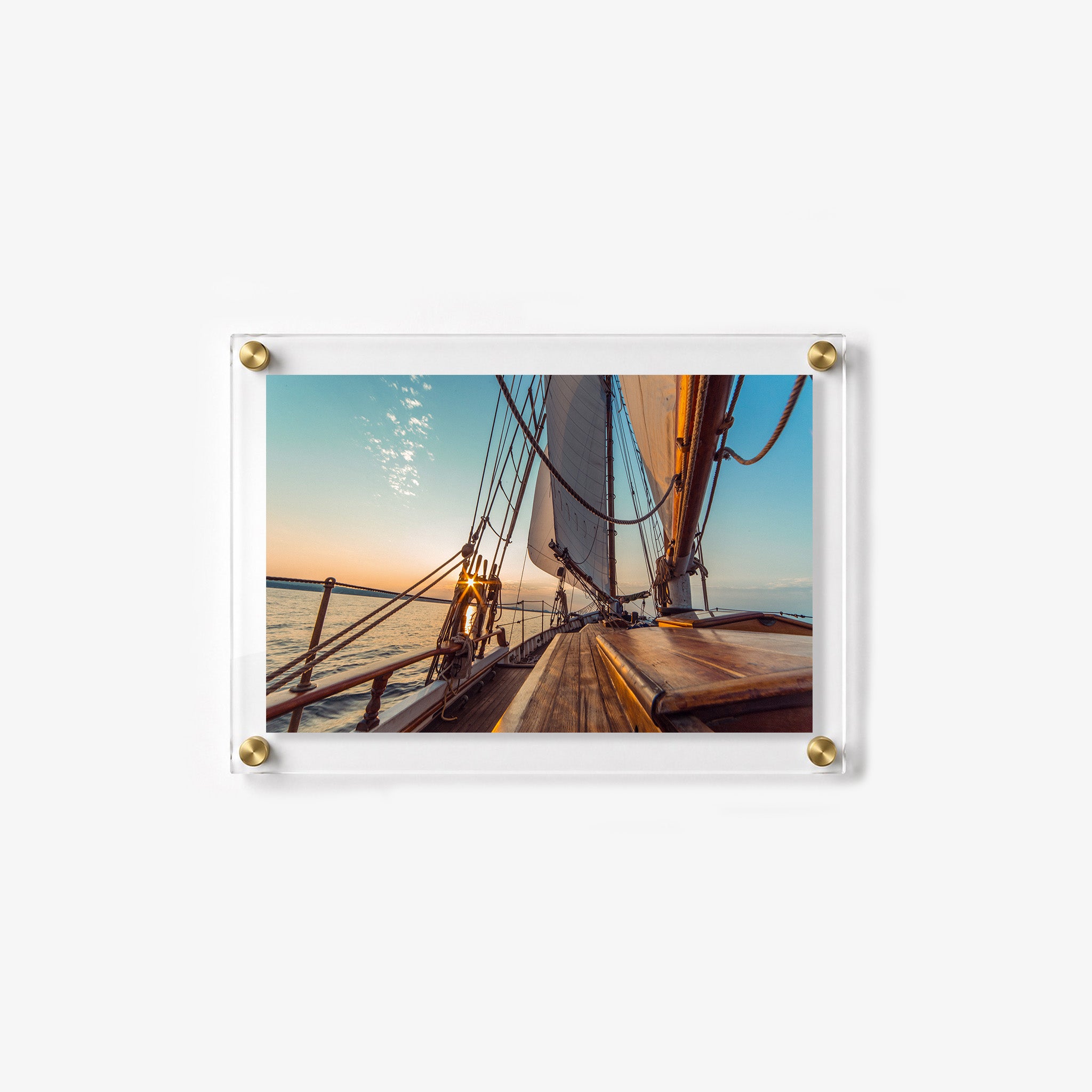 Coastal wall art featuring tall sails, rope rigging, and a glowing ocean horizon