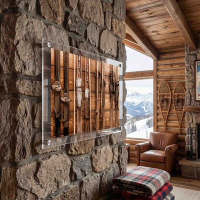 Old wooden skis with leather bindings displayed at a mountain cabin