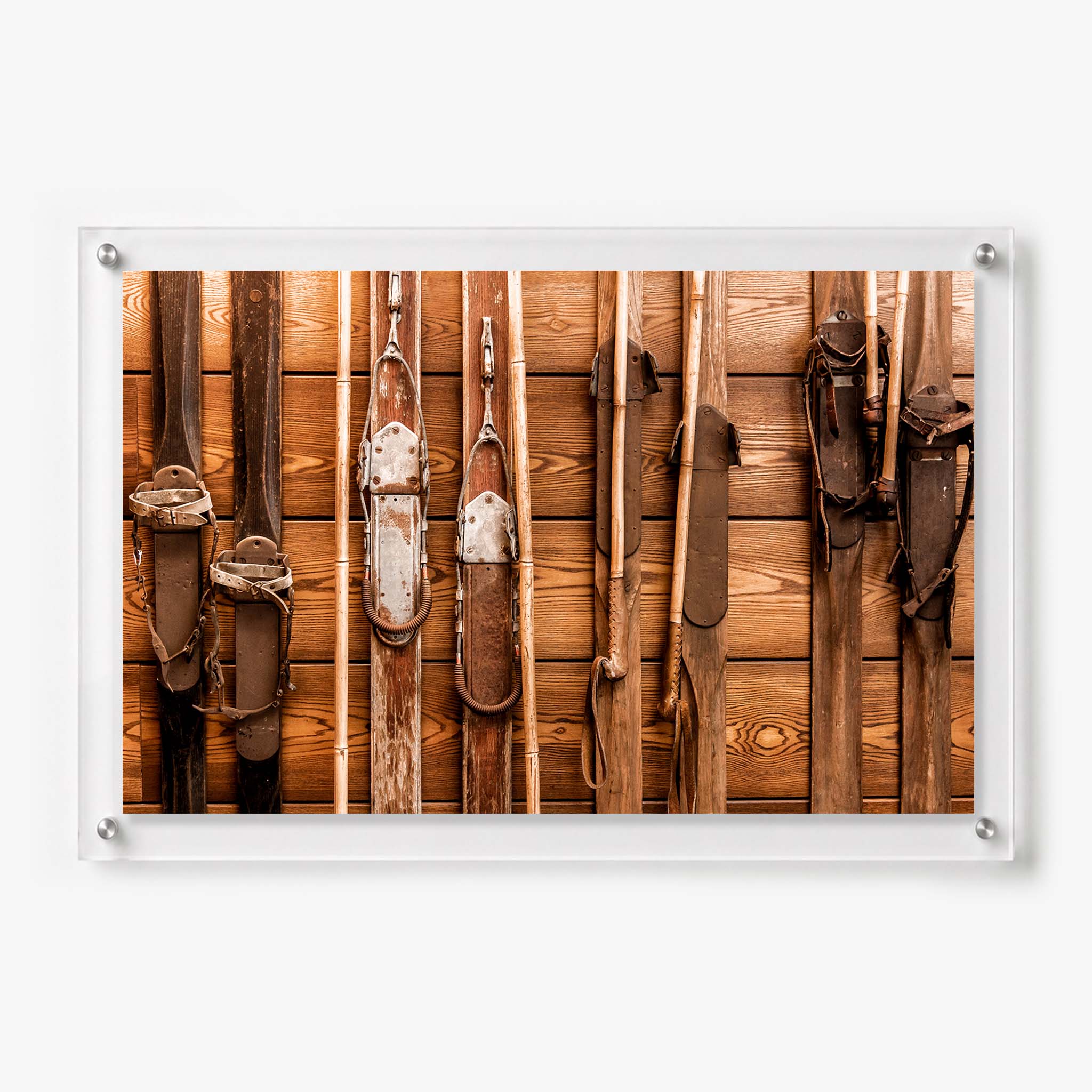 Rustic ski lodge wall art showing a collection of weathered wooden skis and poles