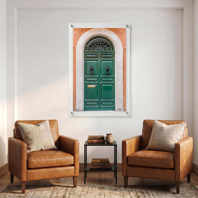 Vertical acrylic print of a traditional European door displayed in a warm sitting area