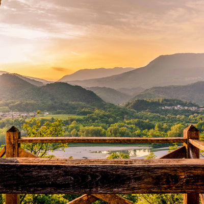 Peaceful valley and distant mountains under a glowing sky
