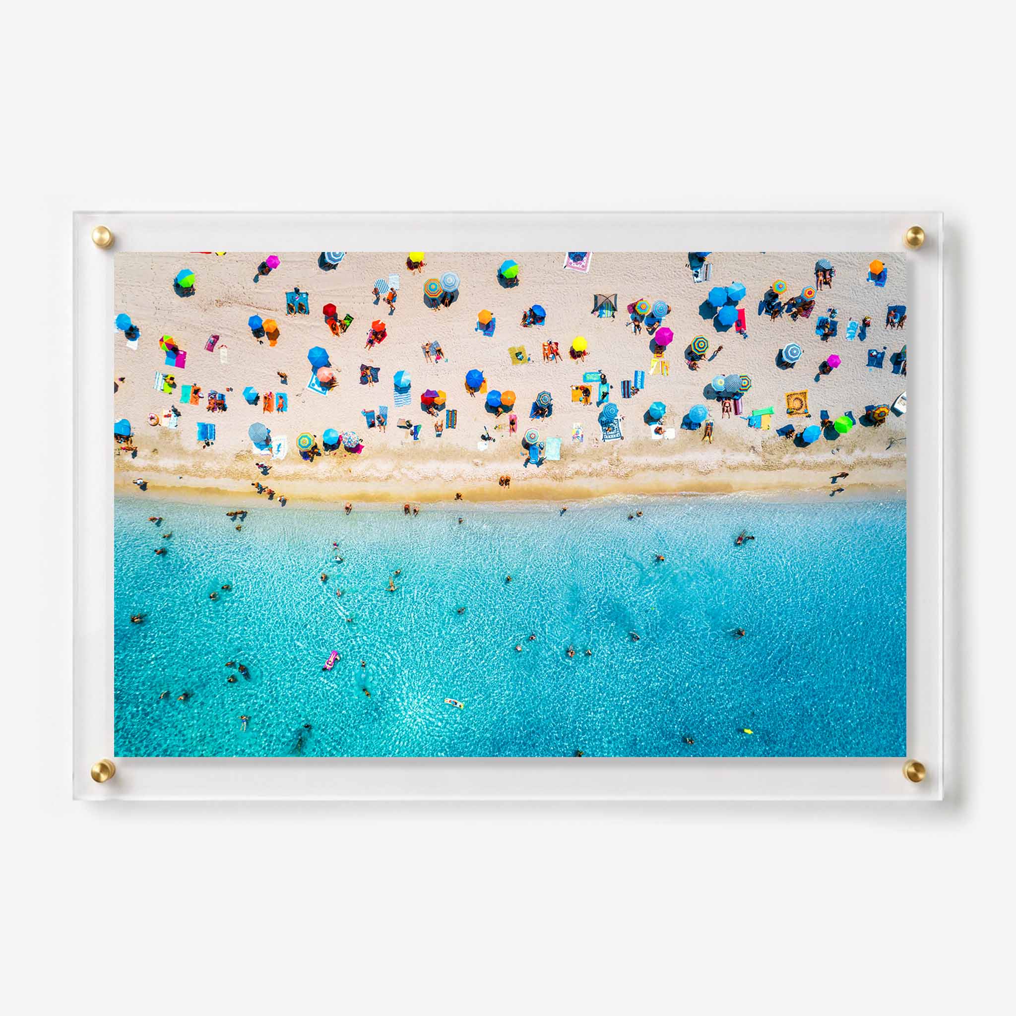 Acrylic wall art featuring a busy beach filled with colorful umbrellas