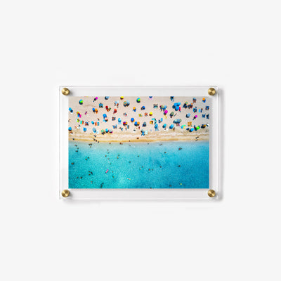 Summer wall art featuring swimmers in blue water beside a busy sandy beach