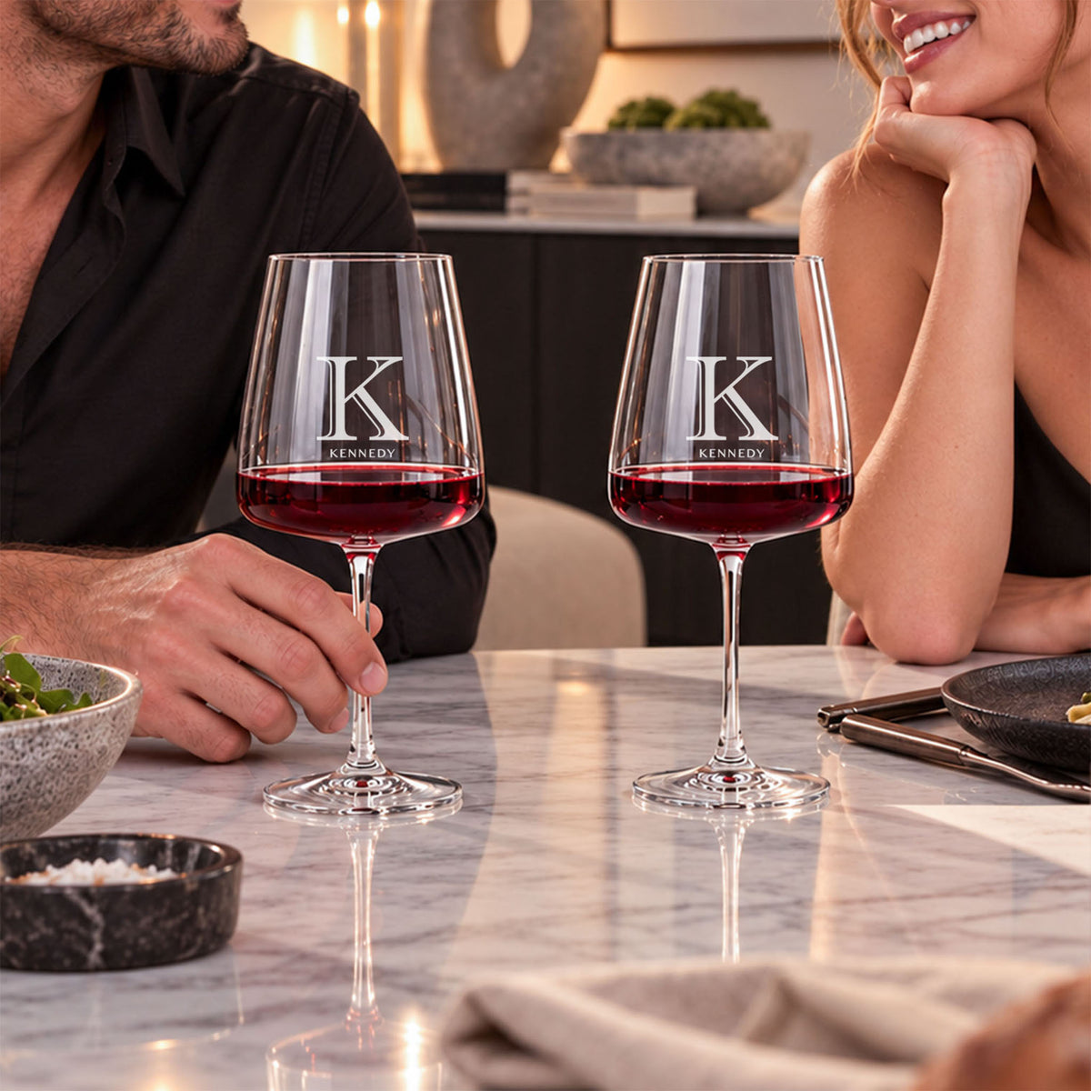 couple enjoying engraved Cabernet wine glasses