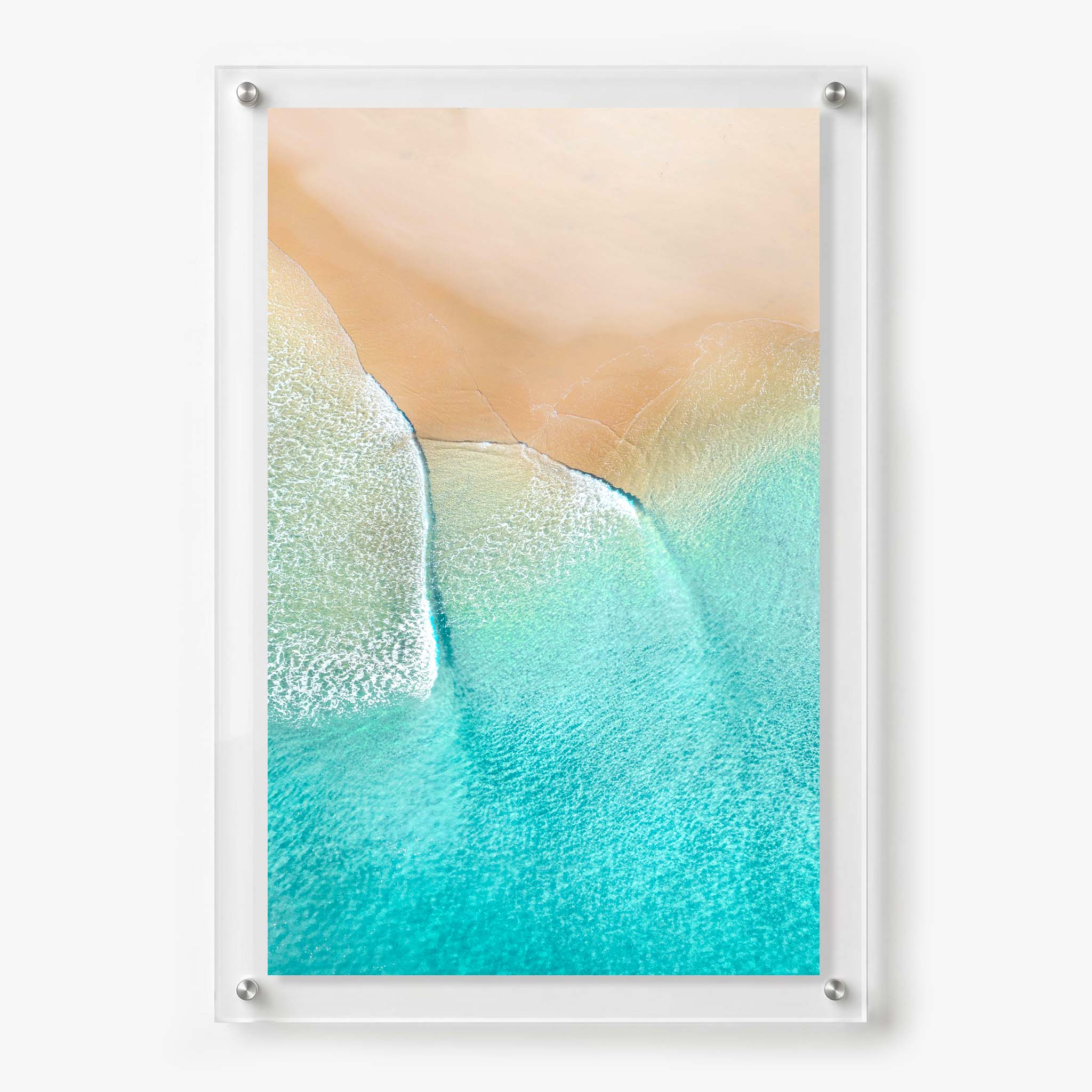Acrylic wall art featuring an aerial view of turquoise ocean waves