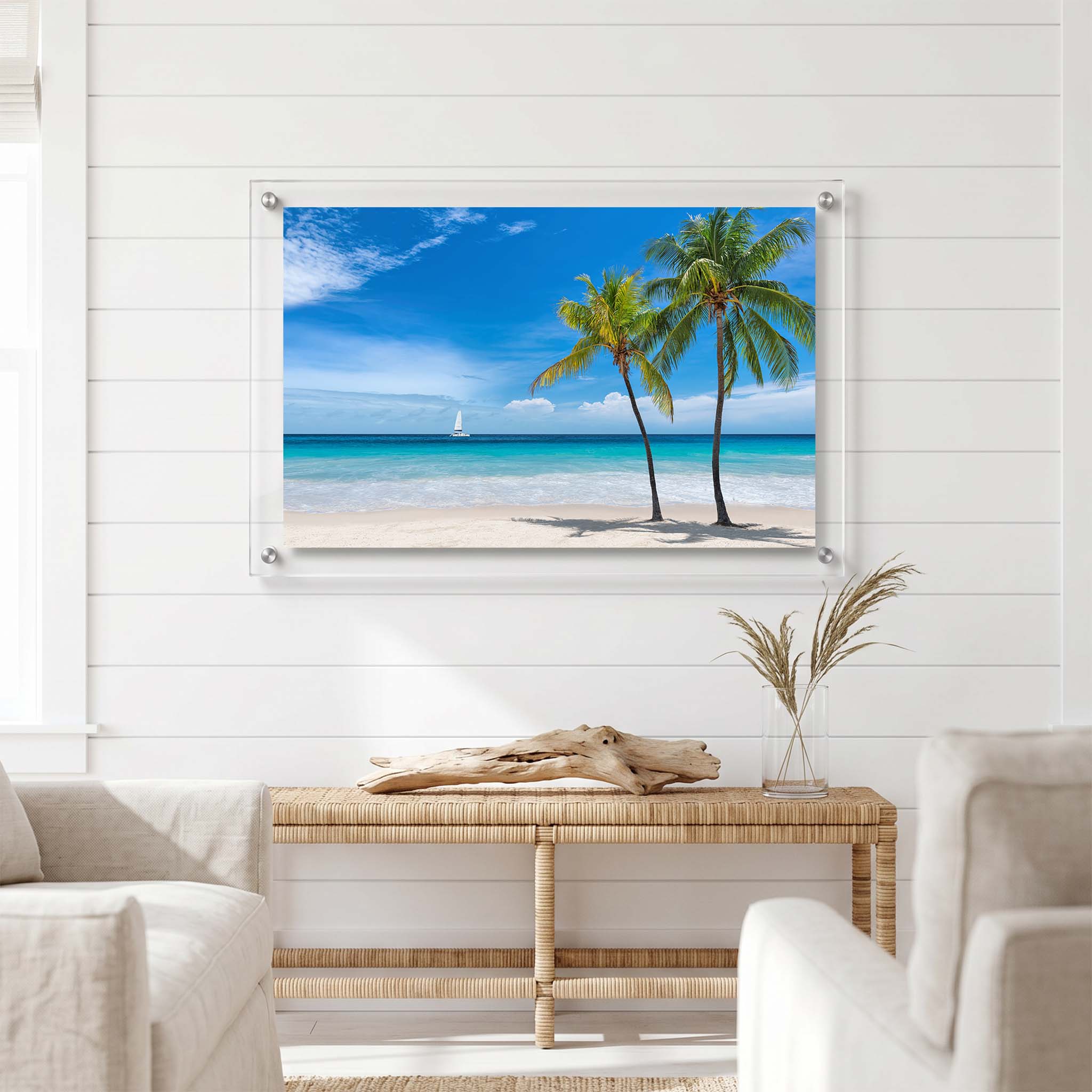 Coastal acrylic wall art showing swaying palm trees displayed in a bright room