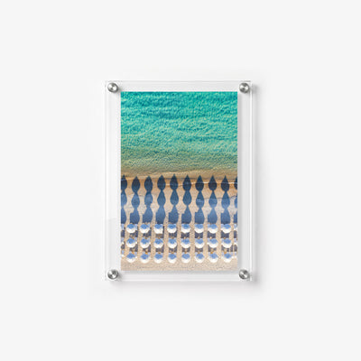Vertical beach wall art featuring symmetrical umbrellas