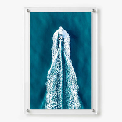 Acrylic wall art featuring an aerial view of a motorboat speeding across deep blue water