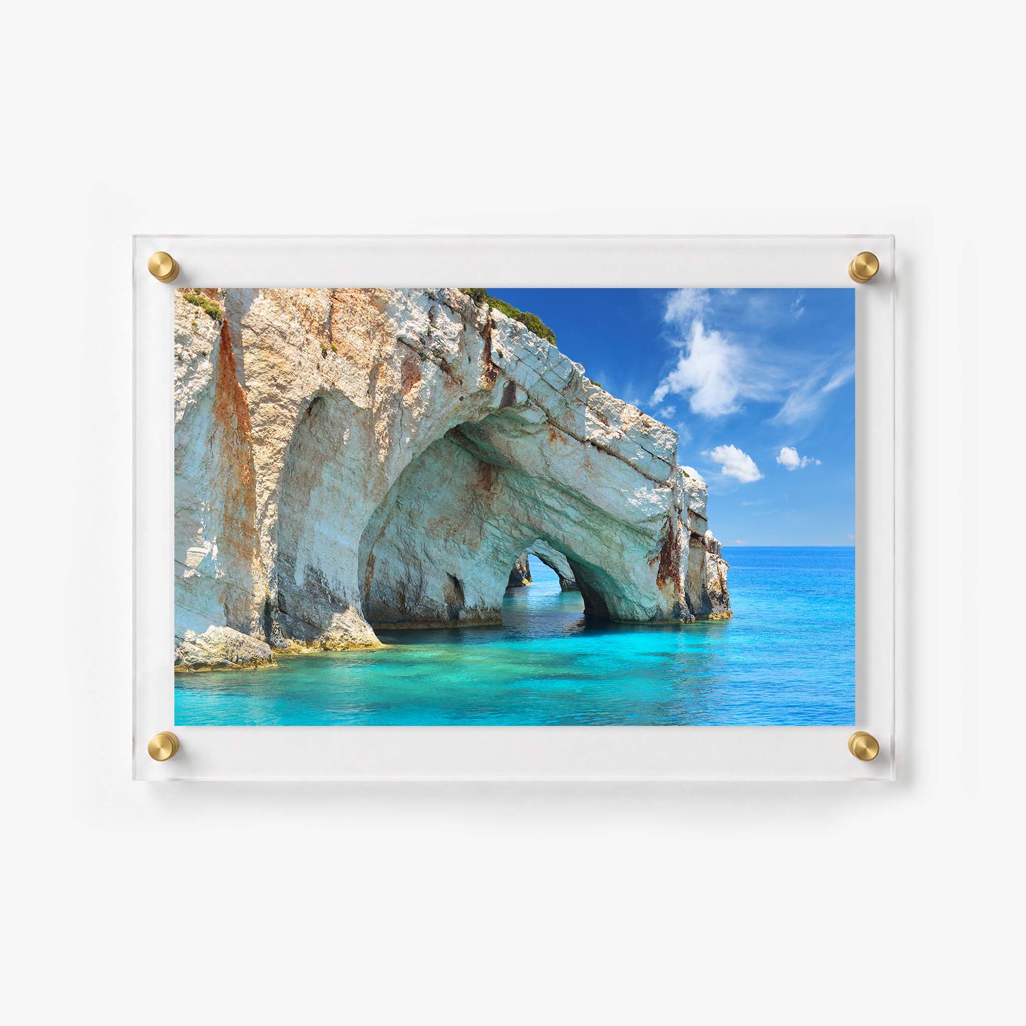 Coastal acrylic print showing turquoise water flowing through a large rocky arch