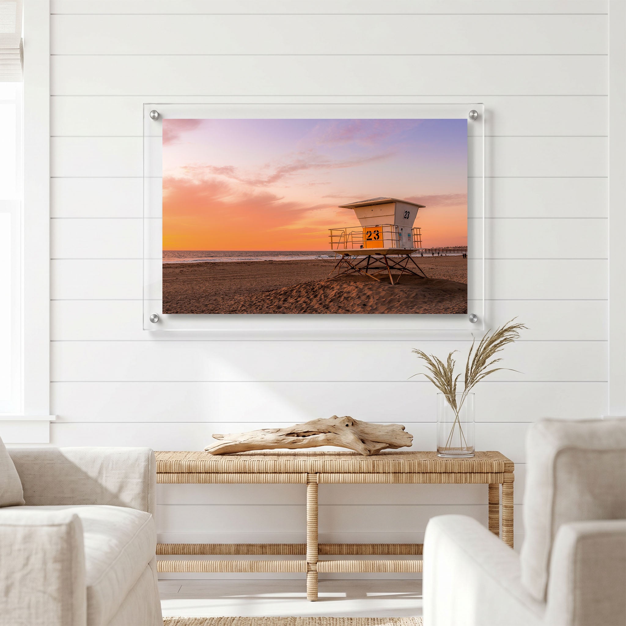 Beach wall art showing a white lifeguard tower displayed in a bright room