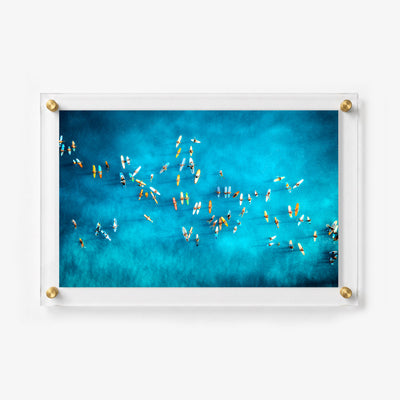 Overhead surf scene with colorful boards scattered across water