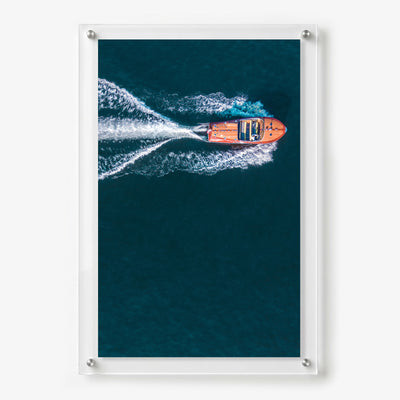 Acrylic wall art featuring a wooden speedboat creating a white wake
