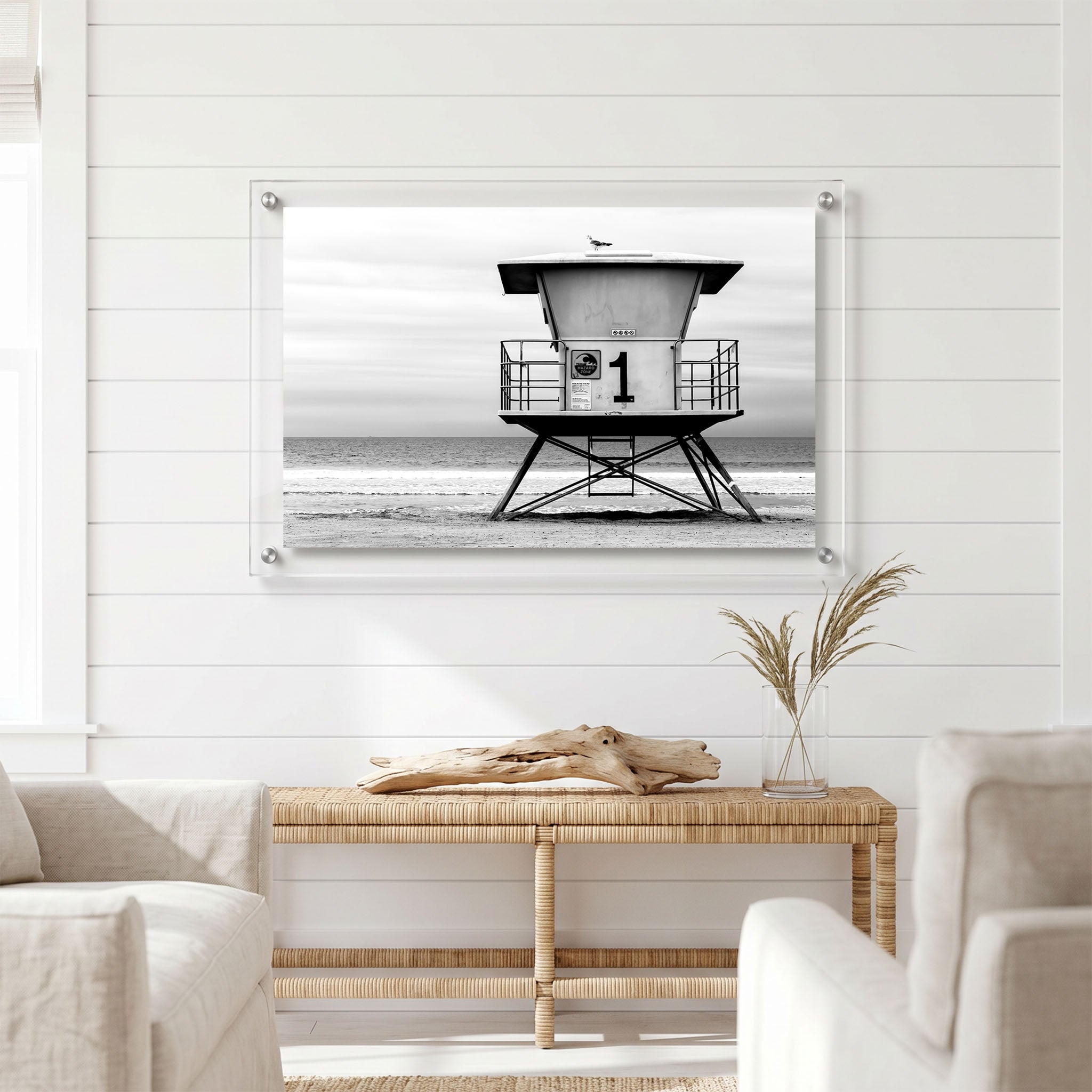 Minimalist beach wall art featuring an empty lifeguard tower displayed in a bright room