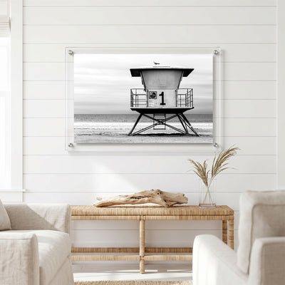 Minimalist beach wall art featuring an empty lifeguard tower displayed in a bright room