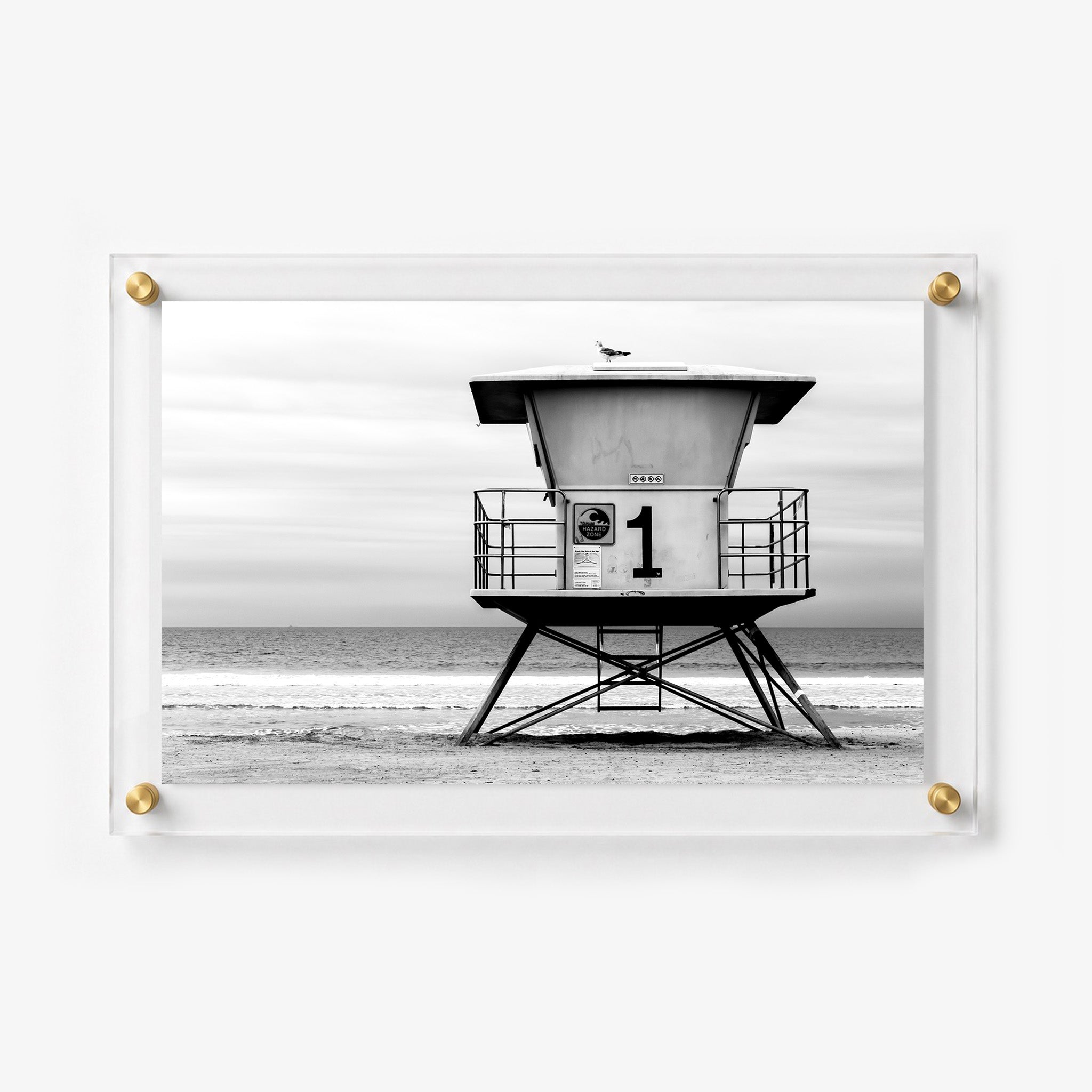 Black and white coastal print showing a lifeguard station with a seagull perched on the roof