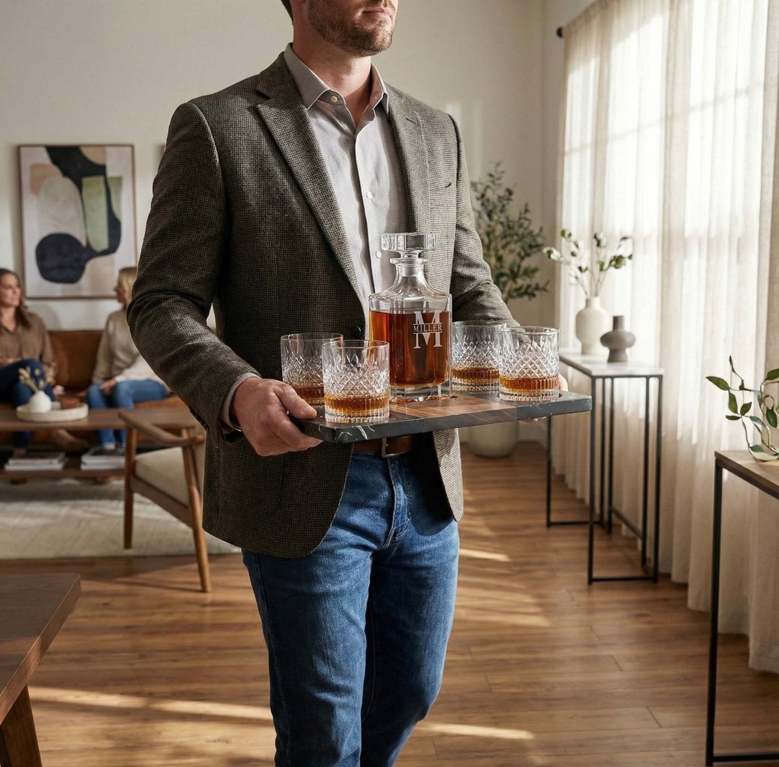a man holding the Winslow Whiskey Gift Set - Marble Tray w/ Carson Decanter & Truman Glasses