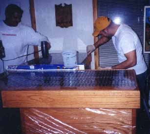 Buddies helping finish the bar top