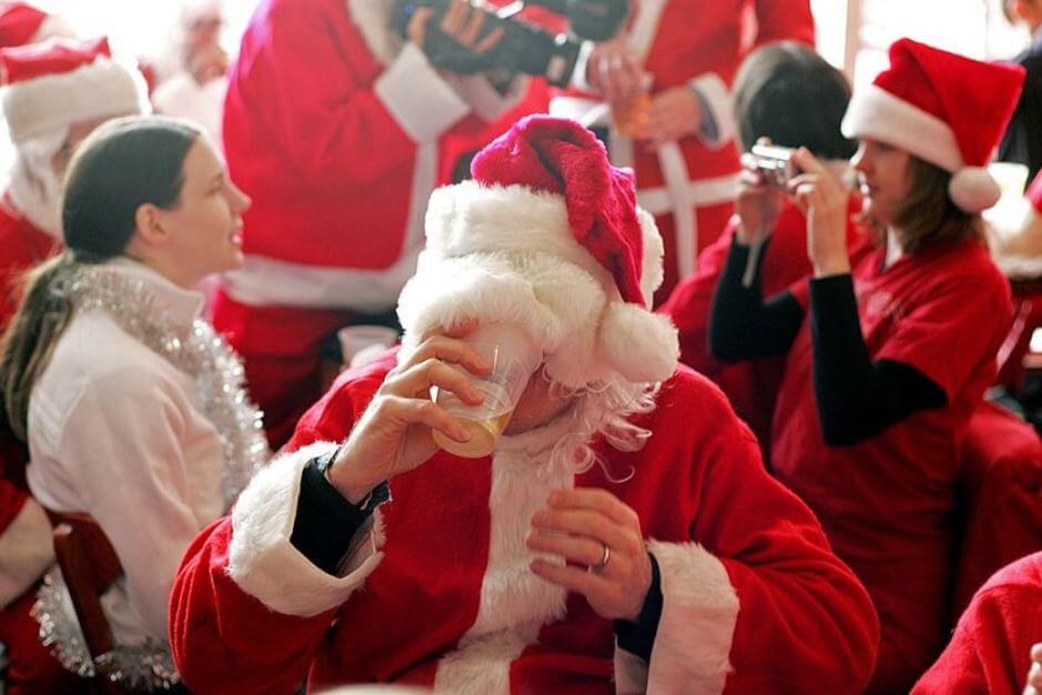Santa Claus Drinking Beer at a Party