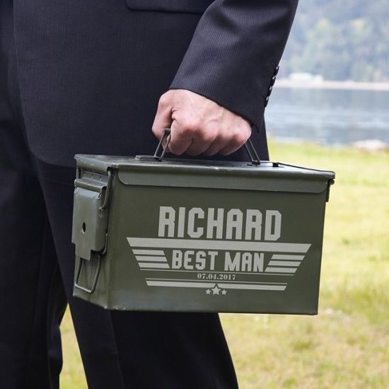 Man in suit holding ammo can for groomsmen
