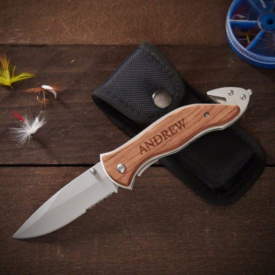 Personalized serrated hunting knife on top of carrying pouch