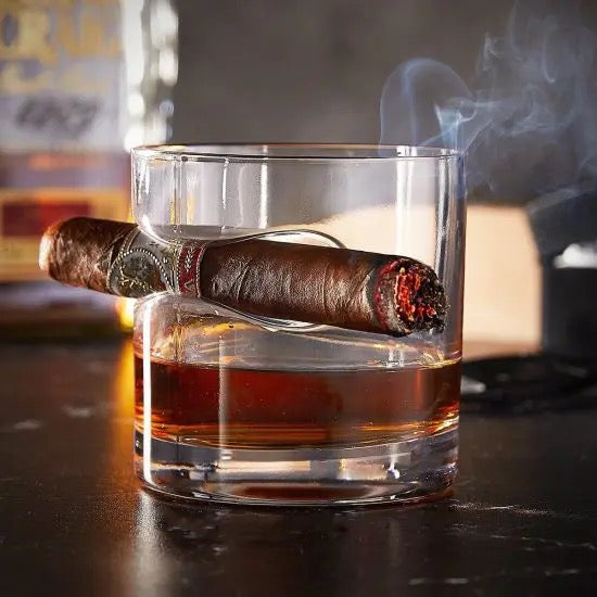 Cigar glass with lit cigar and whiskey