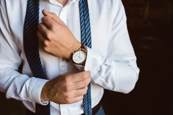 Man wearing a watch and suit outfit