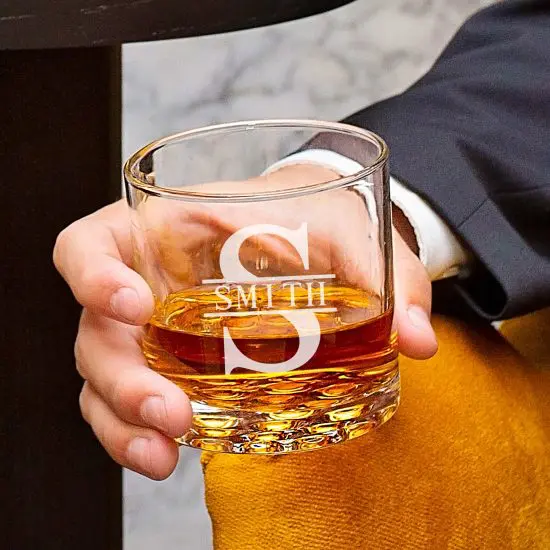 man holding bourbon glass