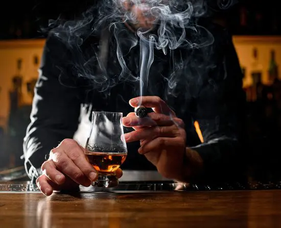 man with glencairn smoking a cigar