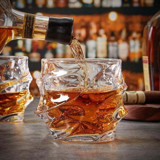 Whiskey being poured into sculpted whiskey glass