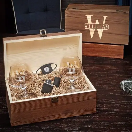 Cognac glasses and cigar accessories inside wood box
