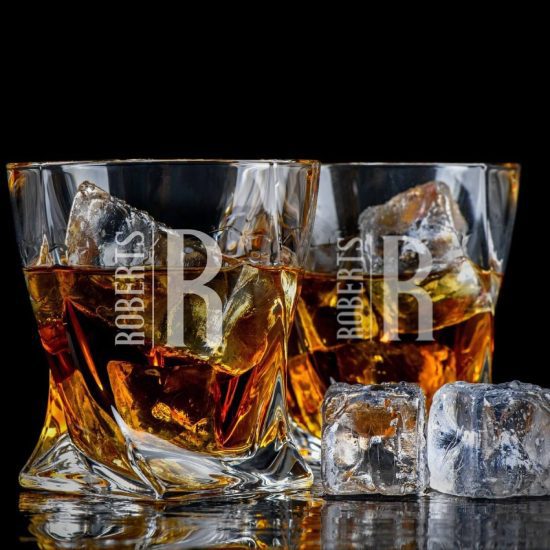 Two twist whiskey glasses with ice and whiskey
