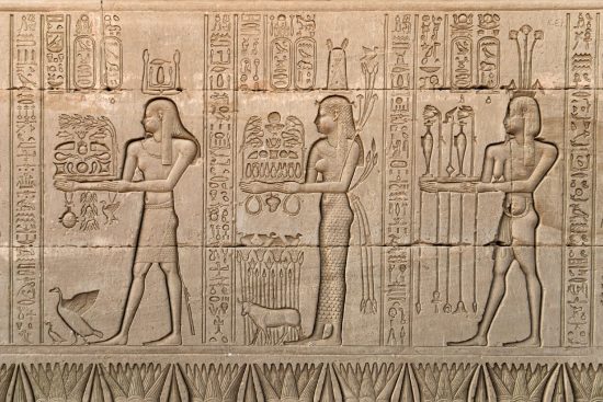 Hieroglyphs. Egyptian wall relief from Hathor temple depicting wine