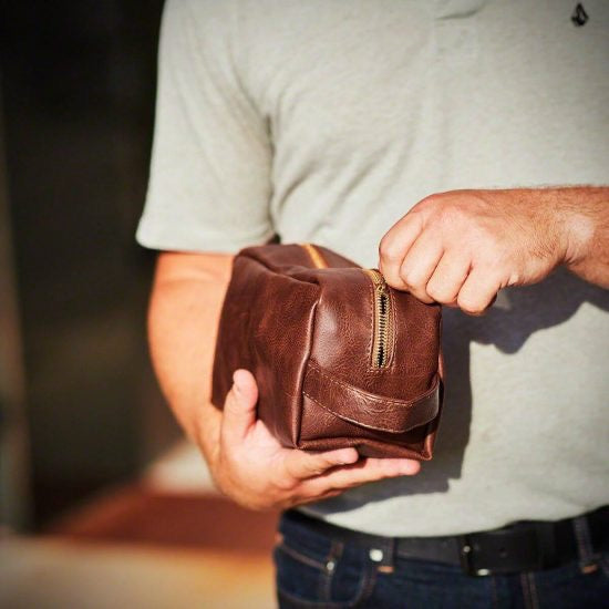 Man opening a dopp kit