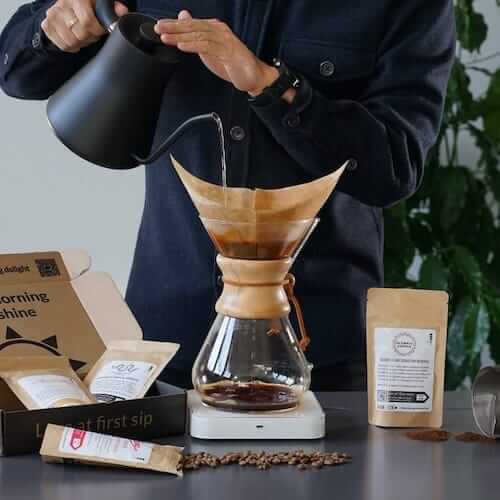 Man pouring coffee into coffee filter container