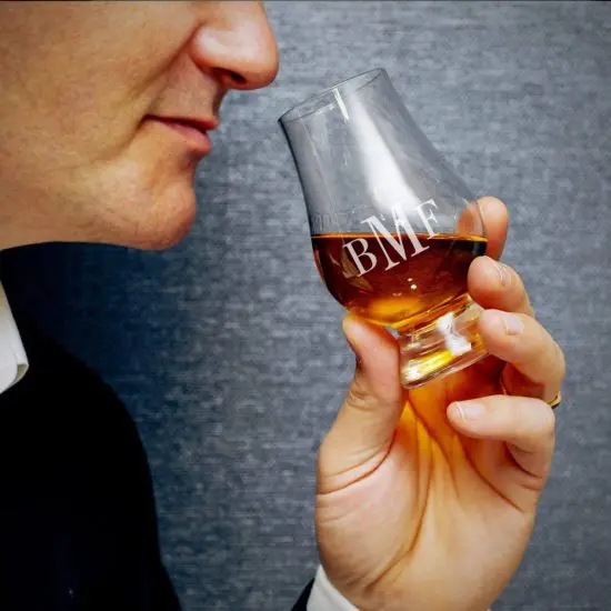 Man smelling whiskey from a Glencairn glass