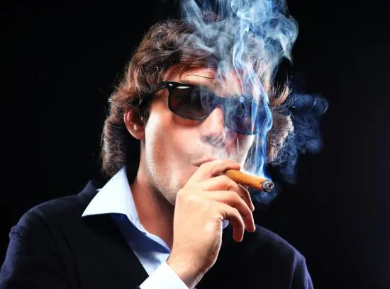 Man with sunglasses smoking a cigar