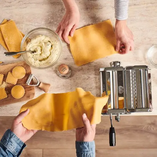 People making pasta with Marcato pasta maker